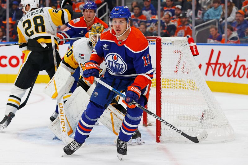 Oct 25, 2024; Edmonton, Alberta, CAN; Edmonton Oilers forward Mattias Janmark (13) looks for a loose puck in front of Pittsburgh Penguins goaltender Joel Blomqvist (30) during the first period at Rogers Place. Mandatory Credit: Perry Nelson-Imagn Images