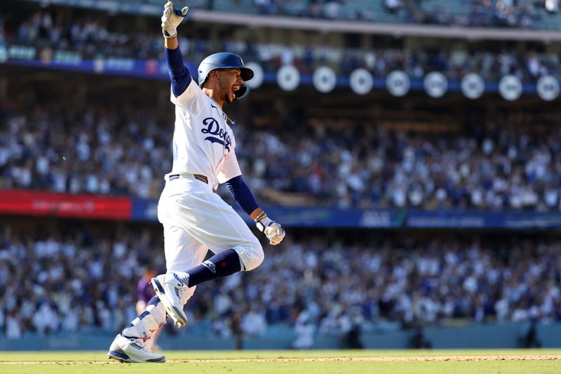 Sep 22, 2024; Los Angeles, California, USA;  Los Angeles Dodgers right fielder Mookie Betts (50) celebrates on a game winning home run in bottom of the ninth inning against the Colorado Rockies at Dodger Stadium. Mandatory Credit: Kiyoshi Mio-Imagn Images