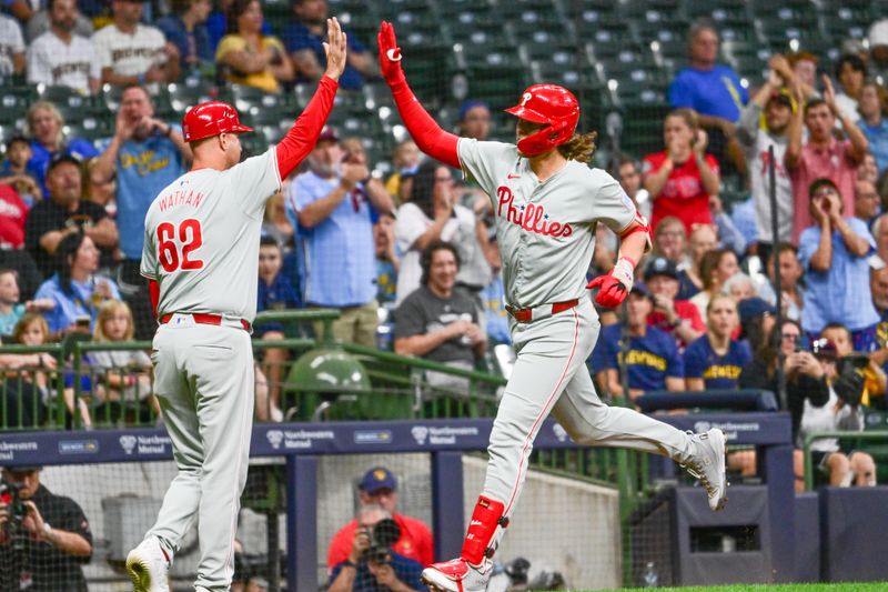 Sep 18, 2024; Milwaukee, Wisconsin, USA; Philadelphia Phillies third baseman Alec Bohm (28) is greeted by third base coach Dusty Watham after hitting a solo home run in the second inning at American Family Field. Mandatory Credit: Benny Sieu-Imagn Images