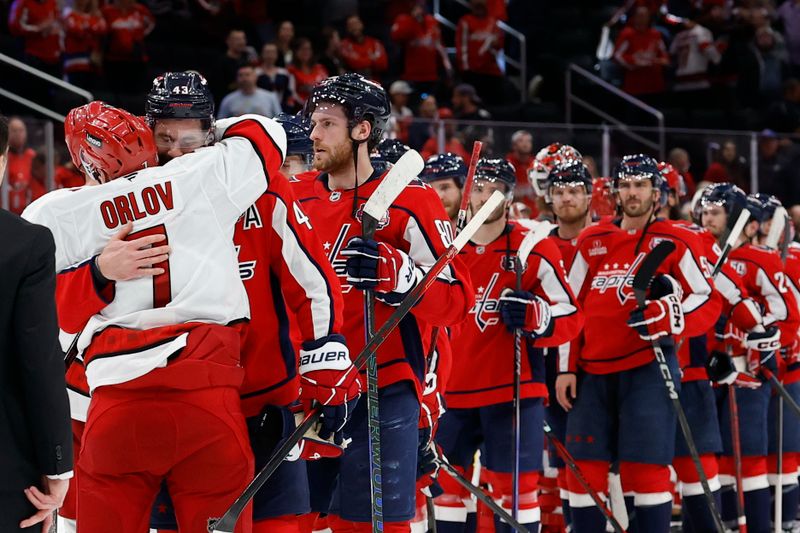 May 15, 2025; Washington, District of Columbia, USA; Carolina Hurricanes defenseman Dmitry Orlov (7) hugs Washington Capitals right wing Tom Wilson (43) in the handshake line after game five of the second round of the 2025 Stanley Cup Playoffs at Capital One Arena. Mandatory Credit: Geoff Burke-Imagn Images
