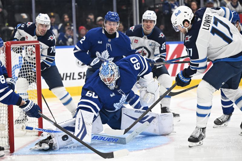 Jan 1, 2026; Toronto, Ontario, CAN;   Toronto Maple Leafs goalie Joseph Woll (60) makes a save on a shot from Winnipeg Jets forward Adam Lowry (17) in the second period at Scotiabank Arena. Mandatory Credit: Dan Hamilton-Imagn Images