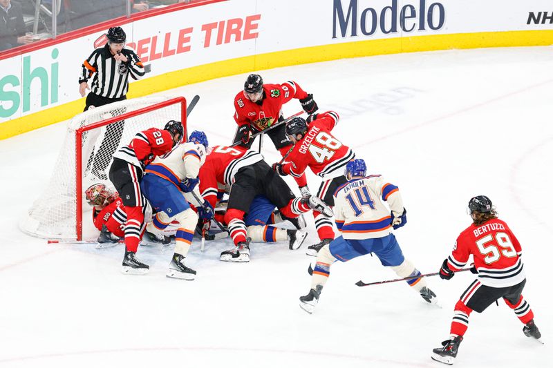 Jan 12, 2026; Chicago, Illinois, USA; Chicago Blackhawks defend against Edmonton Oilers during the second period at United Center. Mandatory Credit: Kamil Krzaczynski-Imagn Images