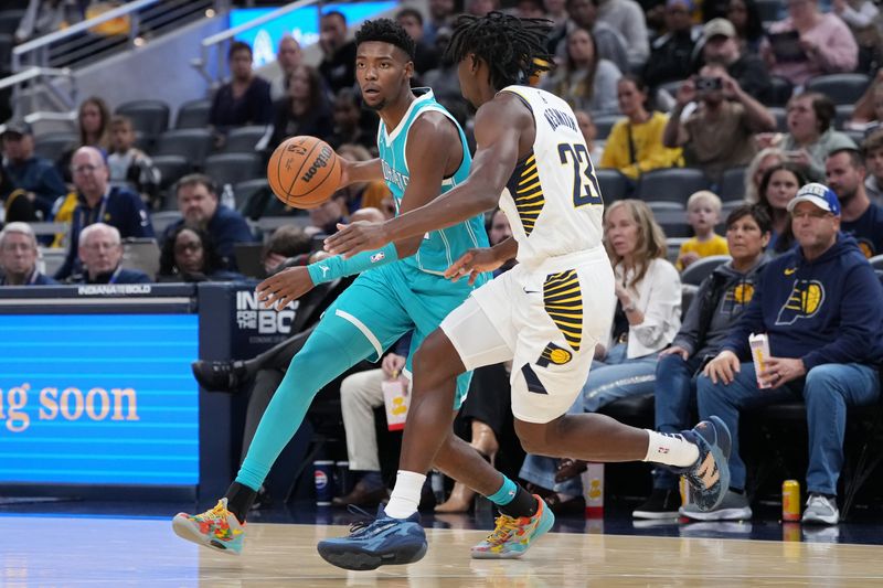 INDIANAPOLIS, INDIANA - OCTOBER 17: Brandon Miller #24 of the Charlotte Hornets dribbles the ball while being guarded by Aaron Nesmith #23 of the Indiana Pacers in the first quarter during a preseason game at Gainbridge Fieldhouse on October 17, 2024 in Indianapolis, Indiana. NOTE TO USER: User expressly acknowledges and agrees that, by downloading and or using this photograph, User is consenting to the terms and conditions of the Getty Images License Agreement. (Photo by Dylan Buell/Getty Images)