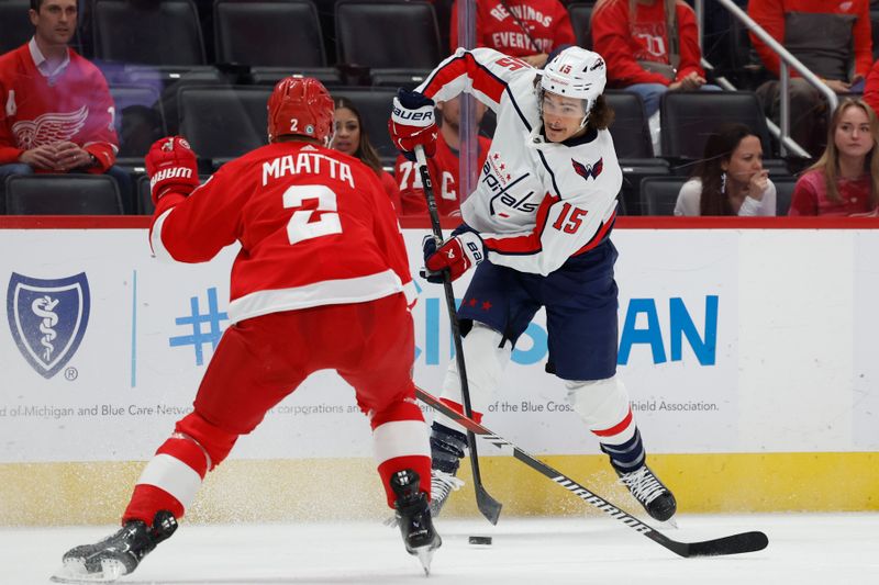 Apr 9, 2024; Detroit, Michigan, USA; Washington Capitals left wing Sonny Milano (15) skates with the puck defended by Detroit Red Wings defenseman Olli Maatta (2) in the first period at Little Caesars Arena. Mandatory Credit: Rick Osentoski-USA TODAY Sports