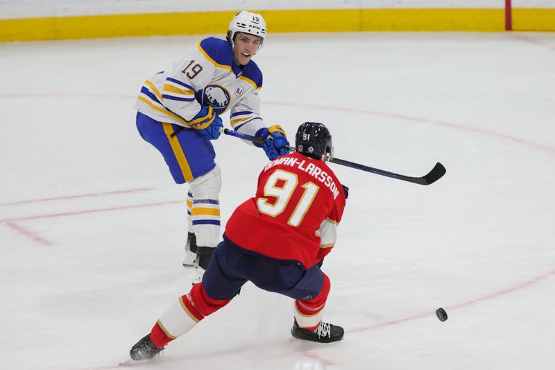 Feb 27, 2024; Sunrise, Florida, USA; Buffalo Sabres center Peyton Krebs (19) passes the puck as Florida Panthers defenseman Oliver Ekman-Larsson (91) defends during the third period at Amerant Bank Arena. Mandatory Credit: Sam Navarro-USA TODAY Sports