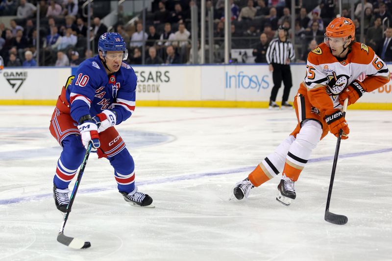 Dec 15, 2025; New York, New York, USA; New York Rangers left wing Artemi Panarin (10) skates with the puck against Anaheim Ducks defenseman Jacob Trouba (65) during the first period at Madison Square Garden. Mandatory Credit: Brad Penner-Imagn Images