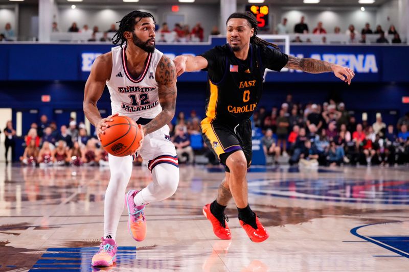 Jan 2, 2024; Boca Raton, Florida, USA; Florida Atlantic Owls guard Jalen Gaffney (12) dribbles the ball against East Carolina Pirates guard Bobby Pettiford Jr. (0) during the second half at Eleanor R. Baldwin Arena. Mandatory Credit: Rich Storry-USA TODAY Sports