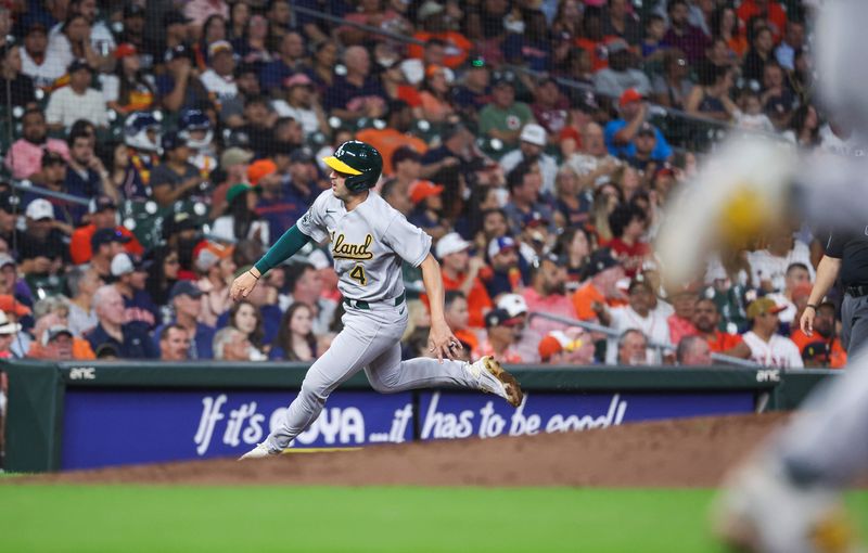 Sep 11, 2023; Houston, Texas, USA; Oakland Athletics third baseman Kevin Smith (4) rounds third base to score a run on an RBI single by shortstop Nick Allen (2) during the fifth inning against the Houston Astros at Minute Maid Park. Mandatory Credit: Troy Taormina-USA TODAY Sports