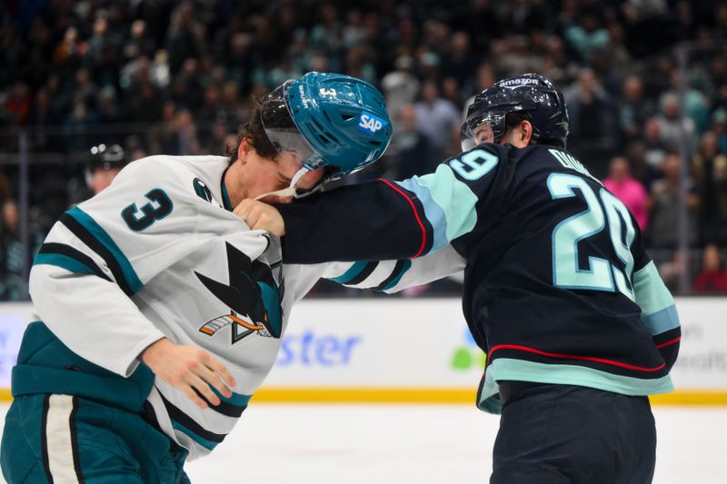 Jan 30, 2025; Seattle, Washington, USA; Seattle Kraken defenseman Vince Dunn (29) fights with San Jose Sharks defenseman Henry Thrun (3) during the second period at Climate Pledge Arena. Mandatory Credit: Steven Bisig-Imagn Images