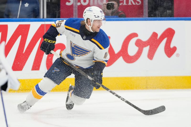 Oct 24, 2024; Toronto, Ontario, CAN; St. Louis Blues defenseman Scott Perunovich (48) skates against the Toronto Maple Leafs during the second period at Scotiabank Arena. Mandatory Credit: John E. Sokolowski-Imagn Images