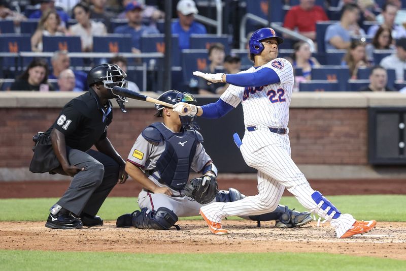 Jun 25, 2025; New York City, New York, USA;  New York Mets right fielder Juan Soto (22) hits a solo home run in the fourth inning against the Atlanta Braves at Citi Field. Mandatory Credit: Wendell Cruz-Imagn Images