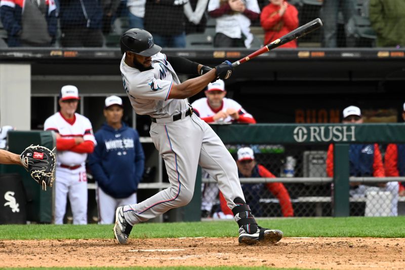 Jun 11, 2023; Chicago, Illinois, USA;  Miami Marlins left fielder Bryan De La Cruz (14) hits a two RBI double against the Chicago White Sox during the ninth inning at Guaranteed Rate Field. Mandatory Credit: Matt Marton-USA TODAY Sports