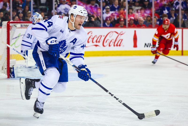 Jan 18, 2024; Calgary, Alberta, CAN; Toronto Maple Leafs defenseman Morgan Rielly (44) controls the puck against the Calgary Flames during the second period at Scotiabank Saddledome. Mandatory Credit: Sergei Belski-USA TODAY Sports