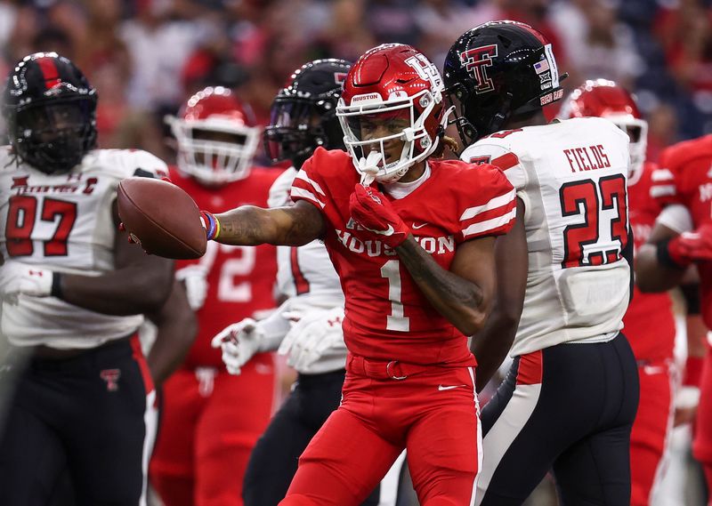 Sep 4, 2021; Houston, Texas, USA; Houston Cougars wide receiver Nathaniel Dell (1) motions after making a catch during the first quarter against the Texas Tech Red Raiders at NRG Stadium. Mandatory Credit: Troy Taormina-USA TODAY Sports