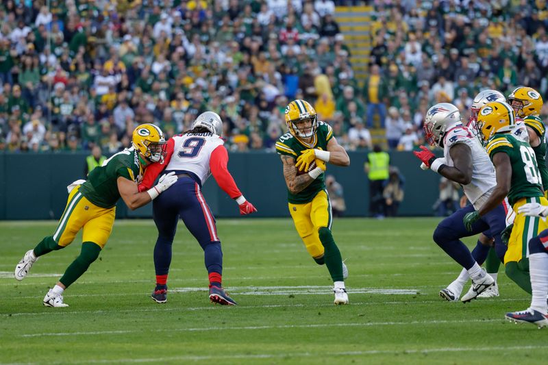 Green Bay Packers wide receiver Christian Watson (9) runs after making a catch against the New England Patriots during an NFL football game Sunday, Oct. 2, 2022, in Green Bay, Wis. (AP Photo/Matt Ludtke)