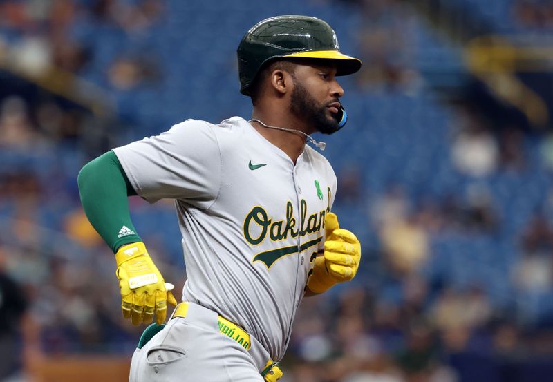 May 30, 2024; St. Petersburg, Florida, USA; Oakland Athletics outfielder Miguel Andujar (22) hits an RBI single against the Tampa Bay Rays during the third inning at Tropicana Field. Mandatory Credit: Kim Klement Neitzel-USA TODAY Sports