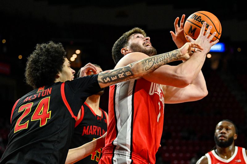 Feb 5, 2026; College Park, Maryland, USA;  Ohio State Buckeyes center Ivan Njegovan (7) is founded by Maryland Terrapins forward Aleks Alston (24) during the first half at Xfinity Center. Mandatory Credit: Tommy Gilligan-Imagn Images