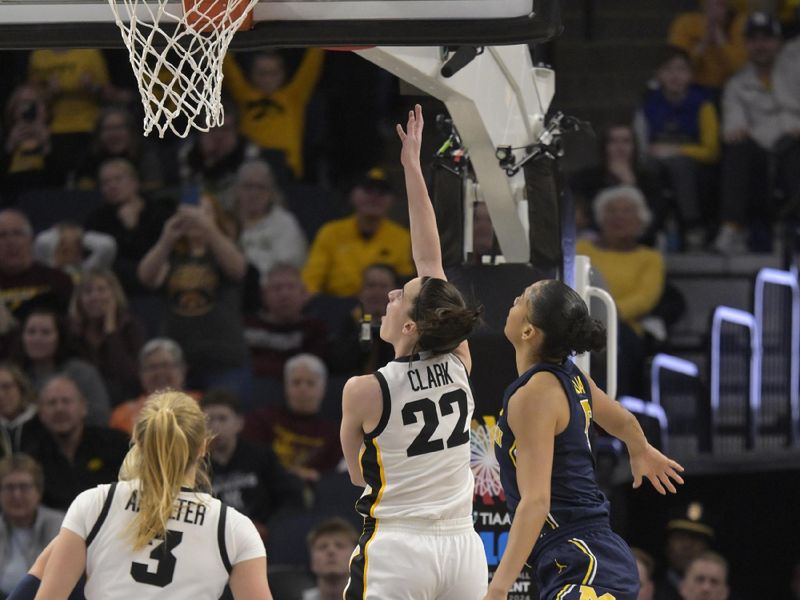 Mar 9, 2024; Minneapolis, MN, USA;  Iowa Hawkeyes guard Caitlin Clark (22) lshots the ball as Michigan Wolverines guard Laila Phelia (5) defends during the first half of a Big Ten Women's Basketball tournament semifinal at Target Center. Mandatory Credit: Nick Wosika-USA TODAY Sports