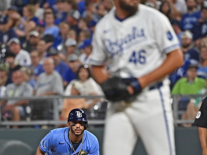 Jul 3, 2024; Kansas City, Missouri, USA;  Tampa Bay Rays shortstop Jose Caballero (7) leads of first base against Kansas City Royals pitcher John Schreiber (46) in the seventh inning at Kauffman Stadium. Mandatory Credit: Peter Aiken-USA TODAY Sports