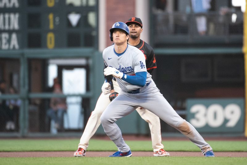 Jun 29, 2024; San Francisco, California, USA; Los Angeles Dodgers two-way player Shohei Ohtani (17) watches the ball hit by catcher Will Smith (16, not pictured) during the tenth inning at Oracle Park. Mandatory Credit: Ed Szczepanski-USA TODAY Sports