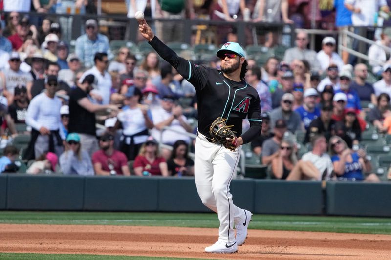 Mar 8, 2024; Salt River Pima-Maricopa, Arizona, USA; Arizona Diamondbacks third baseman Eugenio Suarez (28) makes the play for an out against the Chicago Cubs in the fourth inning at Salt River Fields at Talking Stick. Mandatory Credit: Rick Scuteri-USA TODAY Sports