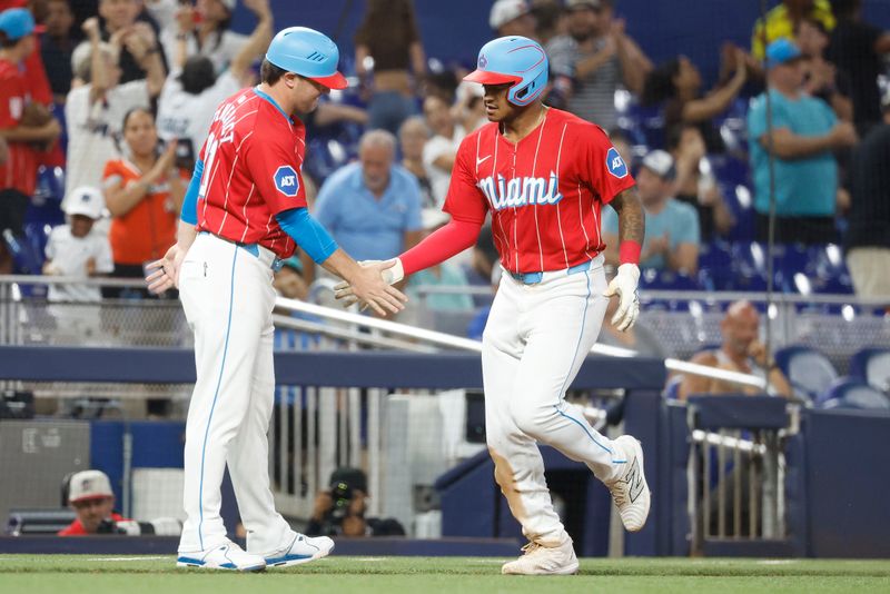 Jul 6, 2024; Miami, Florida, USA; Miami Marlins right fielder Dane Myers (54) celebrates his two run home run with third base coach Griffin Benedict (81) against the Chicago White Sox during the seventh inning at loanDepot Park. Mandatory Credit: Rhona Wise-USA TODAY Sports