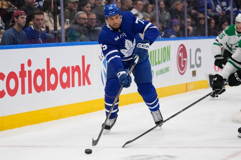 Jan 14, 2025; Toronto, Ontario, CAN; Toronto Maple Leafs forward Ryan Reaves (75) passes the puck against the Dallas Stars during the first period at Scotiabank Arena. Mandatory Credit: John E. Sokolowski-Imagn Images