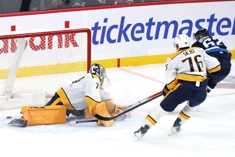 Oct 18, 2025; Winnipeg, Manitoba, CAN; Winnipeg Jets right wing Nino Niederreiter (62) scores on Nashville Predators goaltender Juuse Saros (74) in the first period at Canada Life Centre. Mandatory Credit: James Carey Lauder-Imagn Images