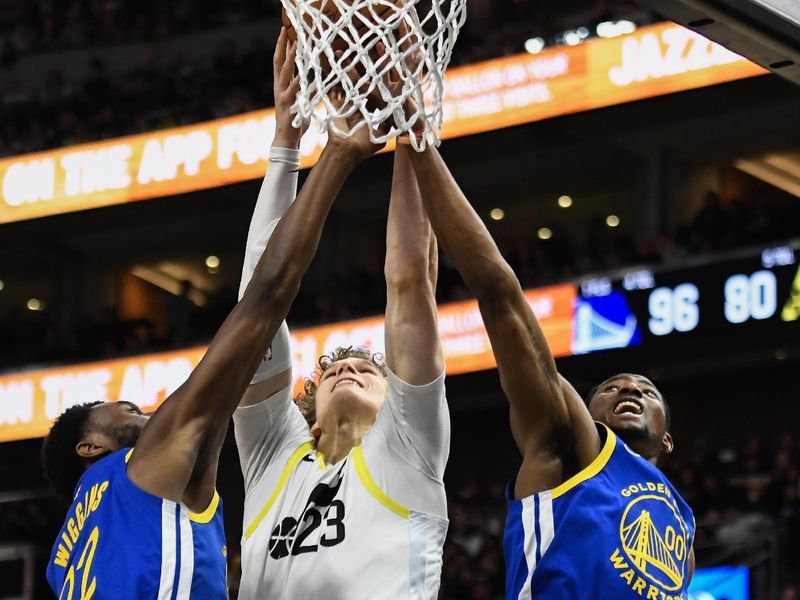 SALT LAKE CITY, UTAH - FEBRUARY 15: Lauri Markkanen #23 of the Utah Jazz shoots between Andrew Wiggins #22 and Jonathan Kuminga #00 of the Golden State Warriors during the second half of a game at Delta Center on February 15, 2024 in Salt Lake City, Utah. NOTE TO USER: User expressly acknowledges and agrees that, by downloading and or using this photograph, User is consenting to the terms and conditions of the Getty Images License Agreement. (Photo by Alex Goodlett/Getty Images)