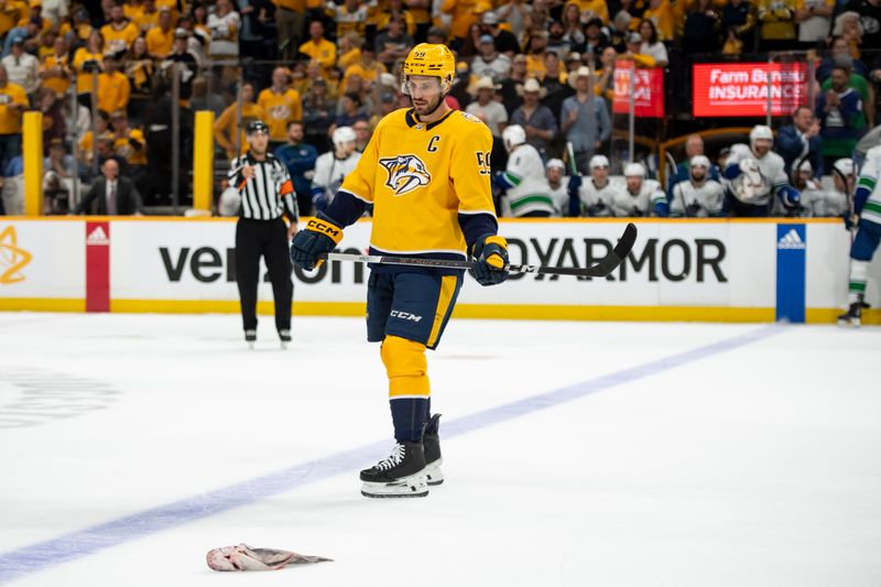 May 3, 2024; Nashville, Tennessee, USA; Nashville Predators defenseman Roman Josi (59) stares a catfish against the Vancouver Canucks during the third period in game six of the first round of the 2024 Stanley Cup Playoffs at Bridgestone Arena. Mandatory Credit: Steve Roberts-USA TODAY Sports