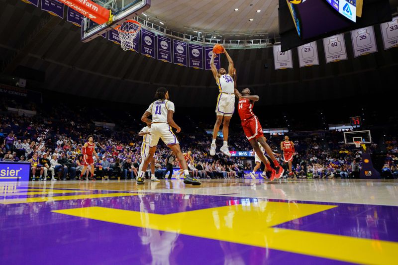 Feb 4, 2023; Baton Rouge, Louisiana, USA; LSU Tigers forward Shawn Phillips (34) rebounds the ball against Alabama Crimson Tide center Charles Bediako (14) during the second half at Pete Maravich Assembly Center. Mandatory Credit: Andrew Wevers-USA TODAY Sports