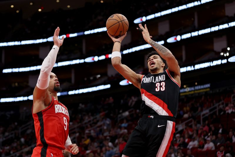 HOUSTON, TEXAS - MARCH 25: Toumani Camara #33 of the Portland Trail Blazers shoots against Dillon Brooks #9 of the Houston Rockets in the first half at Toyota Center on March 25, 2024 in Houston, Texas.  NOTE TO USER: User expressly acknowledges and agrees that, by downloading and or using this photograph, User is consenting to the terms and conditions of the Getty Images License Agreement. (Photo by Tim Warner/Getty Images)