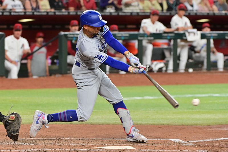 May 1, 2024; Phoenix, Arizona, USA;  Los Angeles Dodgers shortstop Mookie Betts (50) singles in the fourth inning against the Arizona Diamondbacks at Chase Field. Mandatory Credit: Matt Kartozian-USA TODAY Sports