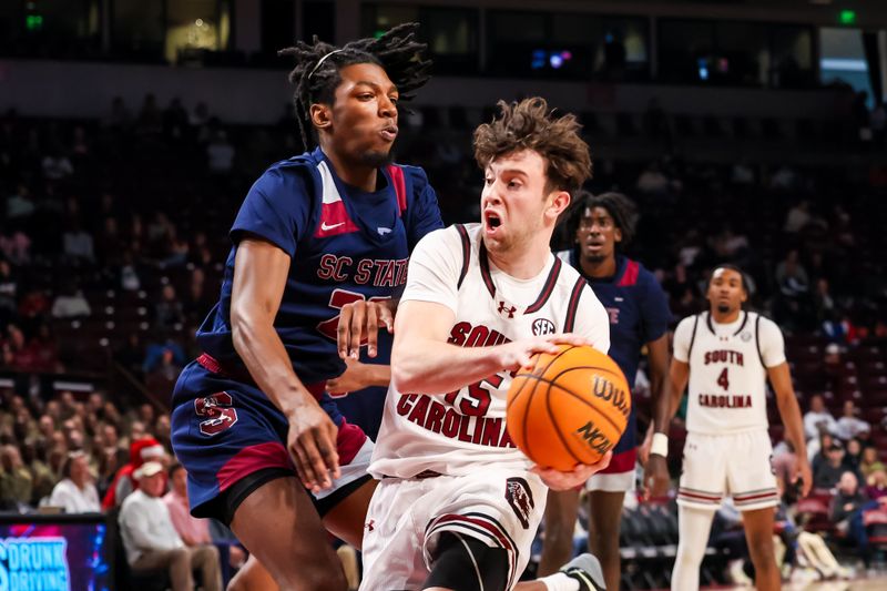 Dec 22, 2025; Columbia, South Carolina, USA; South Carolina Gamecocks guard Eli Ellis (15) looks to pass around South Carolina State Bulldogs forward D'Shay Knights Wright (23) in the first half at Colonial Life Arena. Mandatory Credit: Jeff Blake-Imagn Images