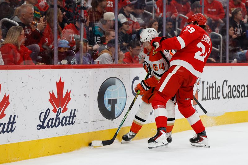 Nov 13, 2025; Detroit, Michigan, USA;  Anaheim Ducks center Mikael Granlund (64) and Detroit Red Wings center Nate Danielson (29) fight for position in the third period at Little Caesars Arena. Mandatory Credit: Rick Osentoski-Imagn Images