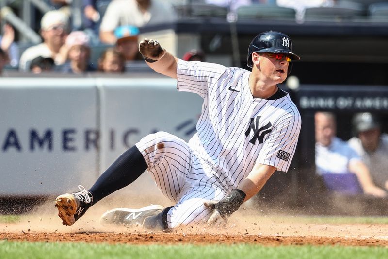 Aug 25, 2024; Bronx, New York, USA;  New York Yankees first baseman DJ LeMahieu (26) slides safely at home plate in the second inning against the Colorado Rockies at Yankee Stadium. Mandatory Credit: Wendell Cruz-USA TODAY Sports