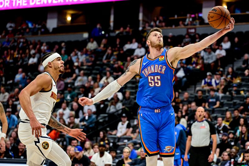 DENVER, COLORADO - OCTOBER 25: Isaiah Hartenstein #55 of the Oklahoma City Thunder has a rebound against Michael Porter Jr. #1 of the Denver Nuggets in the first half at Ball Arena on October 15, 2024 in Denver, Colorado. NOTE TO USER: User expressly acknowledges and agrees that, by downloading and or using this photograph, User is consenting to the terms and conditions of the Getty Images License Agreement. (Photo by Dustin Bradford/Getty Images)