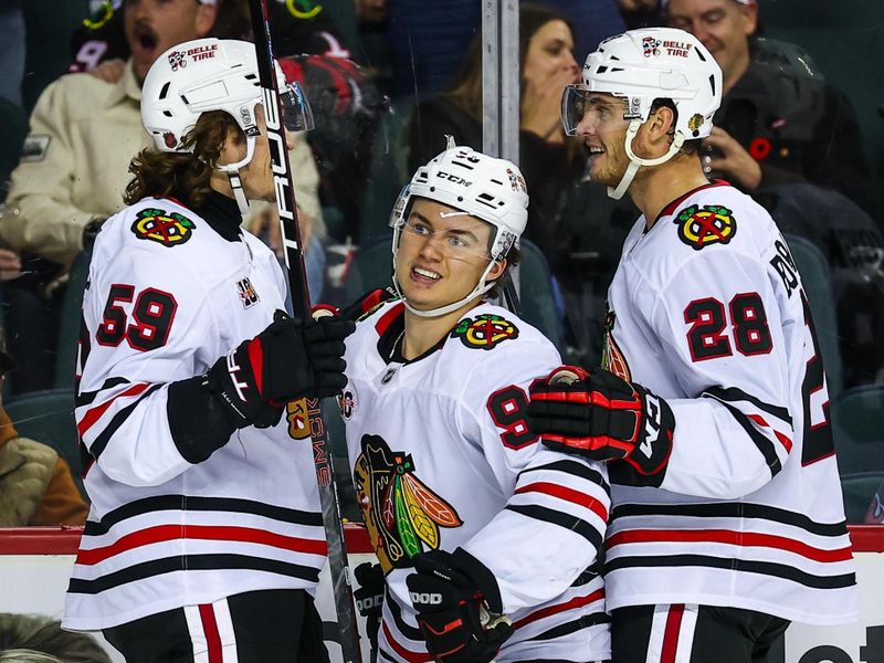 Nov 7, 2025; Calgary, Alberta, CAN; Chicago Blackhawks center Connor Bedard (98) celebrates his goal with teammates against the Calgary Flames during the third period at Scotiabank Saddledome. Mandatory Credit: Sergei Belski-Imagn Images