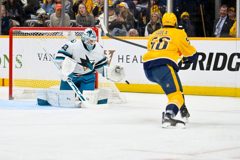 Mar 24, 2026; Nashville, Tennessee, USA;  San Jose Sharks goaltender Alex Nedeljkovic (33) blocks the shot of Nashville Predators left wing Erik Haula (56) during the first period at Bridgestone Arena. Mandatory Credit: Steve Roberts-Imagn Images