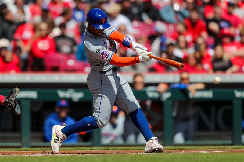 Apr 7, 2024; Cincinnati, Ohio, USA; New York Mets shortstop Francisco Lindor (12) hits a double against the Cincinnati Reds in the first inning at Great American Ball Park. Mandatory Credit: Katie Stratman-USA TODAY Sports