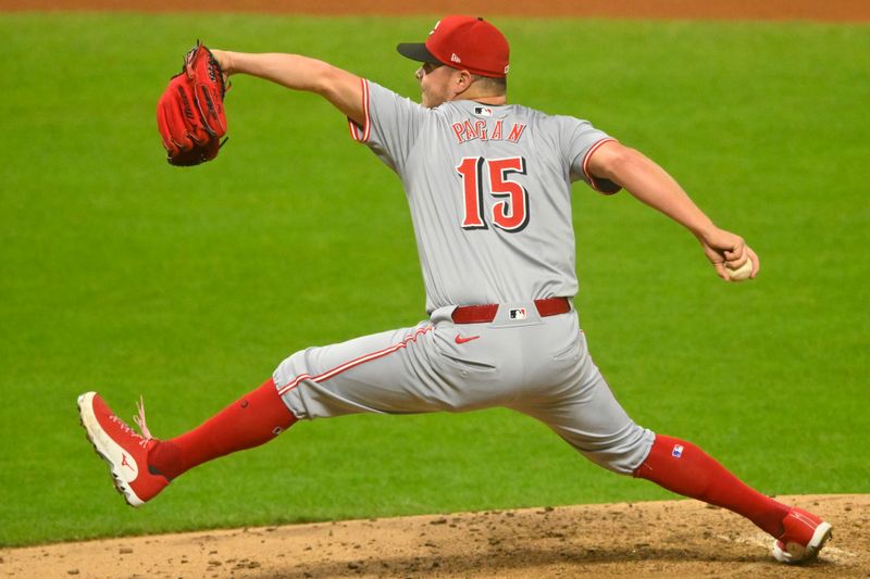 Sep 24, 2024; Cleveland, Ohio, USA; Cincinnati Reds relief pitcher Emilio Pagan (15) pitches in the seventh inning against the Cleveland Guardians at Progressive Field. Mandatory Credit: David Richard-Imagn Images