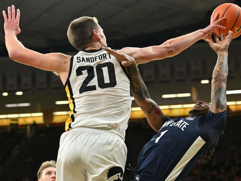 Feb 27, 2024; Iowa City, Iowa, USA; Iowa Hawkeyes forward Payton Sandfort (20) defends the shot of Penn State Nittany Lions guard Ace Baldwin Jr. (1) during the first half at Carver-Hawkeye Arena. Mandatory Credit: Jeffrey Becker-USA TODAY Sports