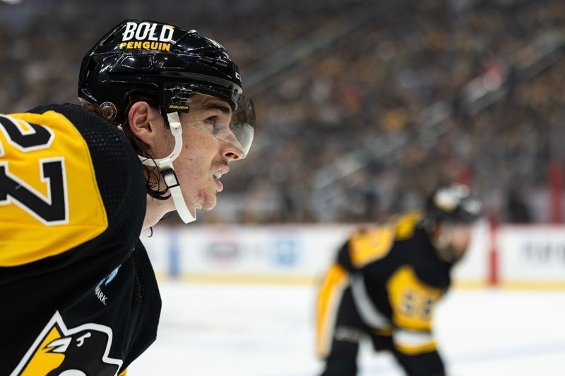 Oct 14, 2023; Pittsburgh, Pennsylvania, USA; Pittsburgh Penguins defenseman Ryan Graves (27) looks up to the time clock during a break in play against the Calgary Flames during the first period at PPG Paints Arena. Mandatory Credit: Scott Galvin-USA TODAY Sports