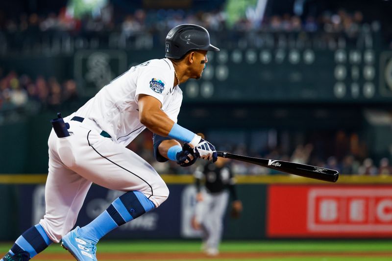 Jun 18, 2023; Seattle, Washington, USA; Seattle Mariners center fielder Julio Rodriguez (44) hits a two-run double against the Chicago White Sox during the third inning at T-Mobile Park. Mandatory Credit: Joe Nicholson-USA TODAY Sports