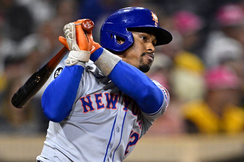 Aug 22, 2024; San Diego, California, USA; New York Mets shortstop Francisco Lindor (12) hits a single against the San Diego Padres during the ninth inning at Petco Park. Mandatory Credit: Orlando Ramirez-USA TODAY Sports