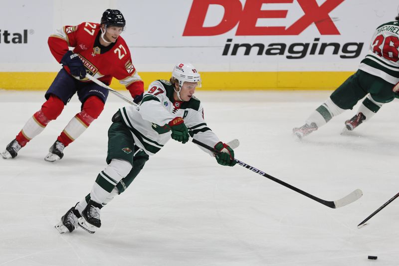 Oct 22, 2024; Sunrise, Florida, USA; Minnesota Wild left wing Kirill Kaprizov (97) moves the puck against the Florida Panthers during the third period at Amerant Bank Arena. Mandatory Credit: Sam Navarro-Imagn Images