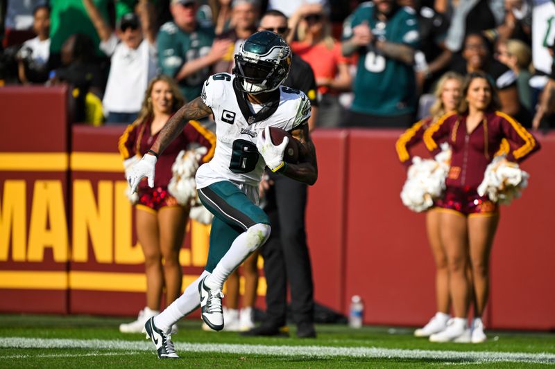 Philadelphia Eagles wide receiver DeVonta Smith (6) runs with the ball after making a catch for a touchdown during the second half of an NFL football game against the Washington Commanders, Sunday, Oct. 29, 2023, in Landover, Md. (AP Photo/Terrance Williams)