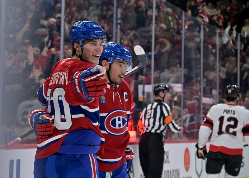 Nov 1, 2025; Montreal, Quebec, CAN; Montreal Canadiens forward Juraj Slafkovsky (20) celebrates with teammate  forward Nick Suzuki (14) after scoring a goal against the Ottawa Senators during the first period at the Bell Centre. Mandatory Credit: Eric Bolte-Imagn Images