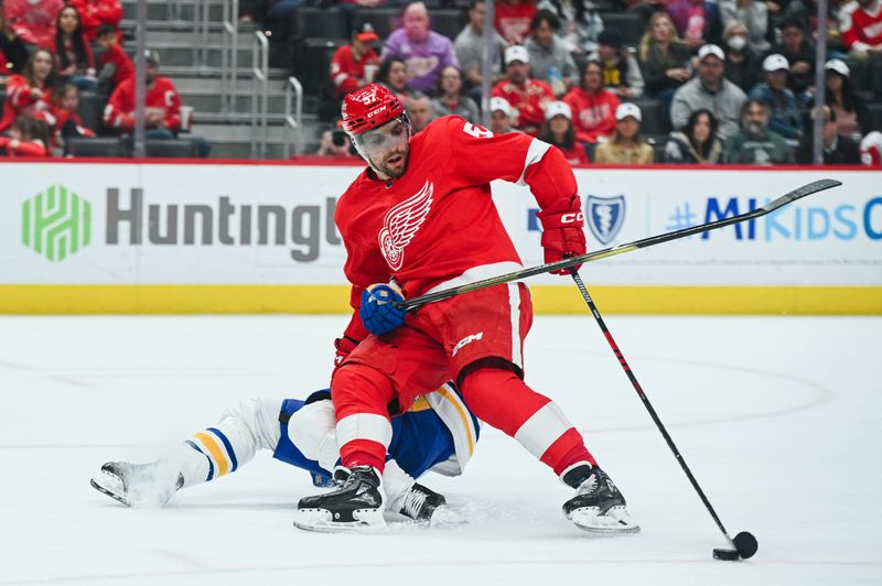 Apr 6, 2023; Detroit, Michigan, USA; Buffalo Sabres defenseman Henri Jokiharju (10) holds Detroit Red Wings left wing David Perron (57) and is called for the penalty during the second period at Little Caesars Arena. Mandatory Credit: Tim Fuller-USA TODAY Sports