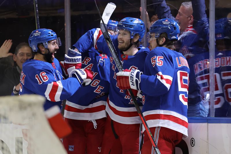 May 13, 2024; New York, New York, USA; New York Rangers defenseman Jacob Trouba (8) celebrates his short handed goal against the Carolina Hurricanes with centers Vincent Trocheck (16) and Barclay Goodrow (21) and defenseman Ryan Lindgren (55) during the first period of game five of the second round of the 2024 Stanley Cup Playoffs at Madison Square Garden. Mandatory Credit: Brad Penner-USA TODAY Sports